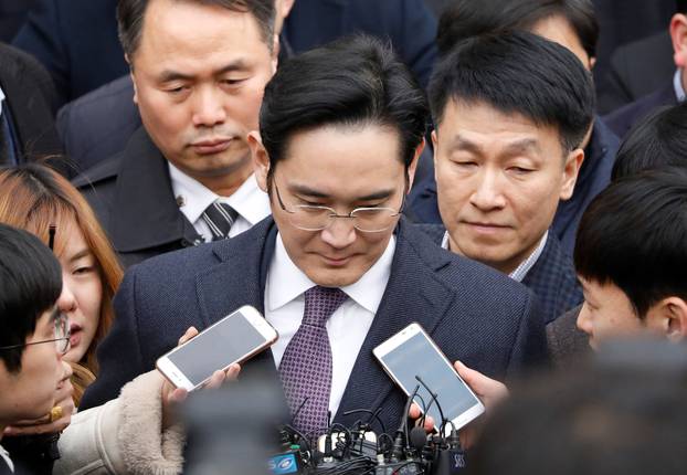 FILE PHOTO - Samsung Group chief, Jay Y. Lee, leaves after attending a court hearing to review a detention warrant request against him at the Seoul Central District Court in Seoul