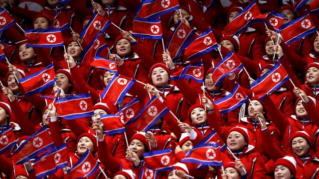 FILE PHOTO: North Korean cheerleaders wave their national flags