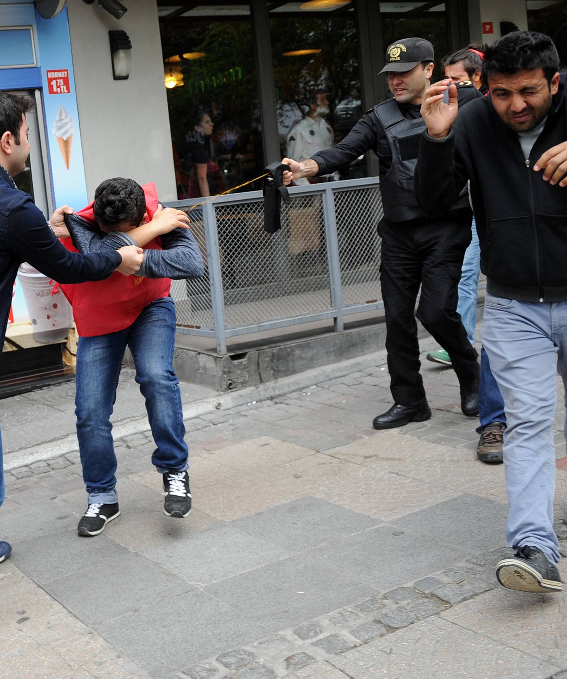 Turkish riot police use pepper spray while detaining a group of protesters who were attempting to defy a ban and march on Taksim Square to celebrate May Day, in Besiktas neighbourhood of Istanbul