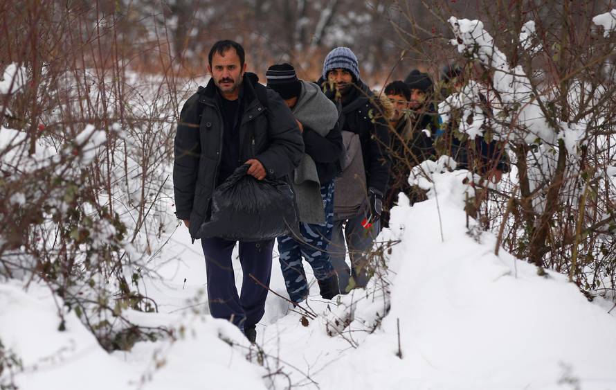 A group of migrants attempts to illegally cross the border into Croatia on the Pljesevica Mountain near Bihac