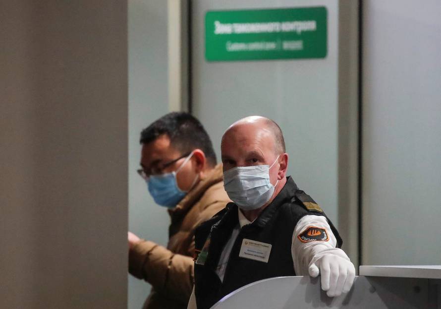 FILE PHOTO: A security service member wearing a mask at Moscow's Sheremetyevo Airport