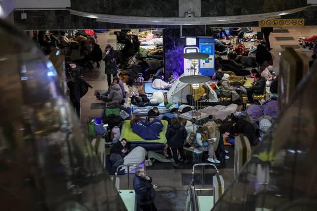 People take shelter inside a metro station during a Russian missile and drone attack in Kyiv