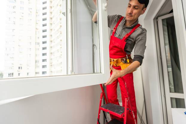 Worker,In,Uniform,Installing,Roller,Window,Blind,Indoors
