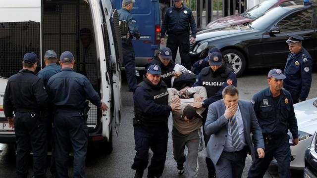 Montenegrin police escort men to a court session with the state attorney in Podgorica