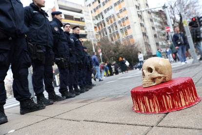 A pro-Ukrainian activists in Serbia delivers a bloody cake and a skull to police guarding Russian embassy in Belgrade
