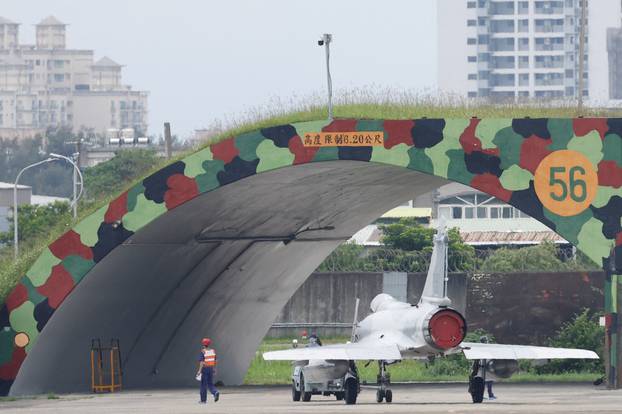 A ground staff walks next to a Taiwan Air Force Mirage 2000-5 at Hsinchu Air Base in Hsinchu