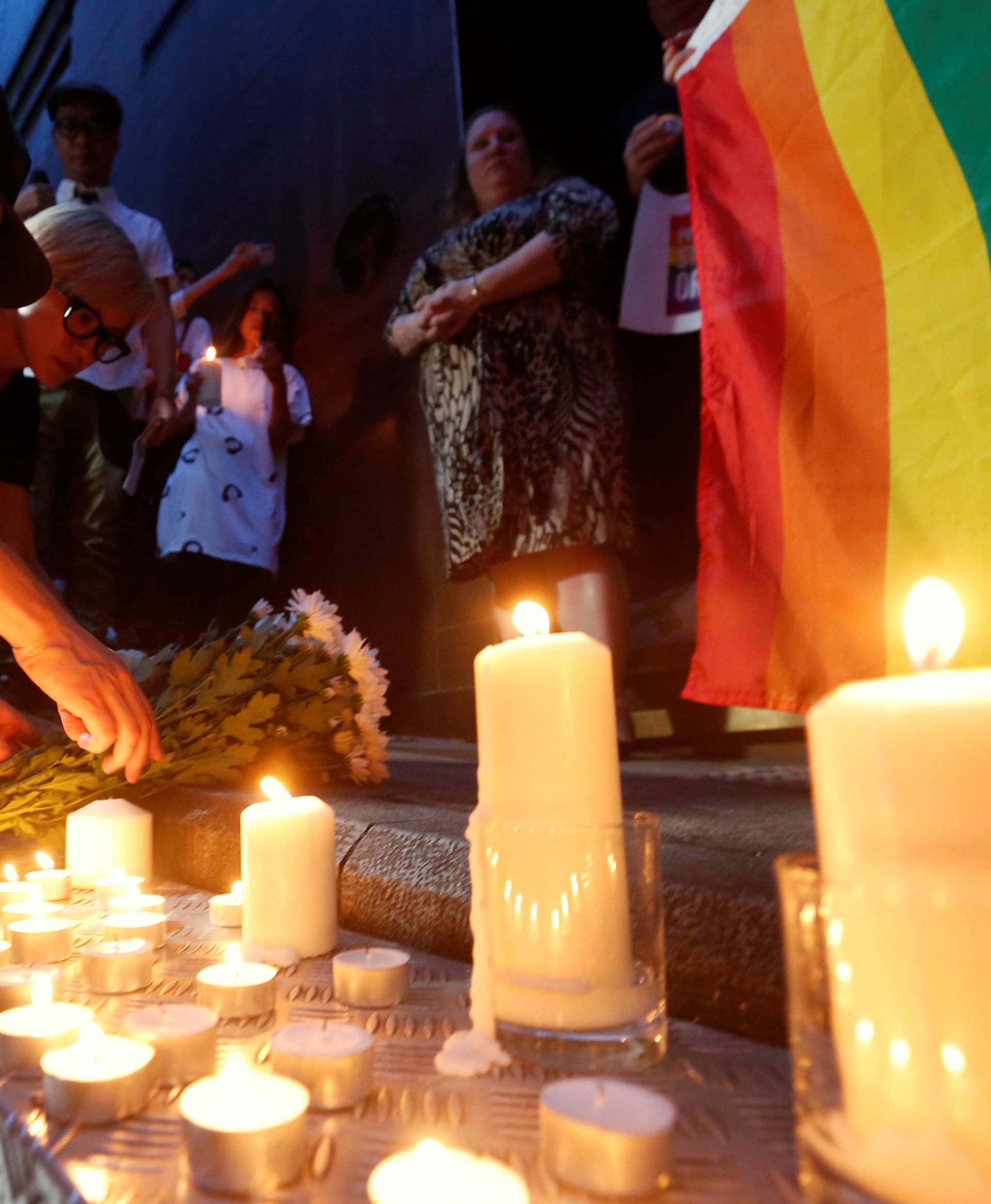 Hong Kong singers Anthony Wong and Denise Ho lay flowers during a candlelight vigil to mourn victims of the shooting at a gay nightclub in Orlando, in Hong Kong