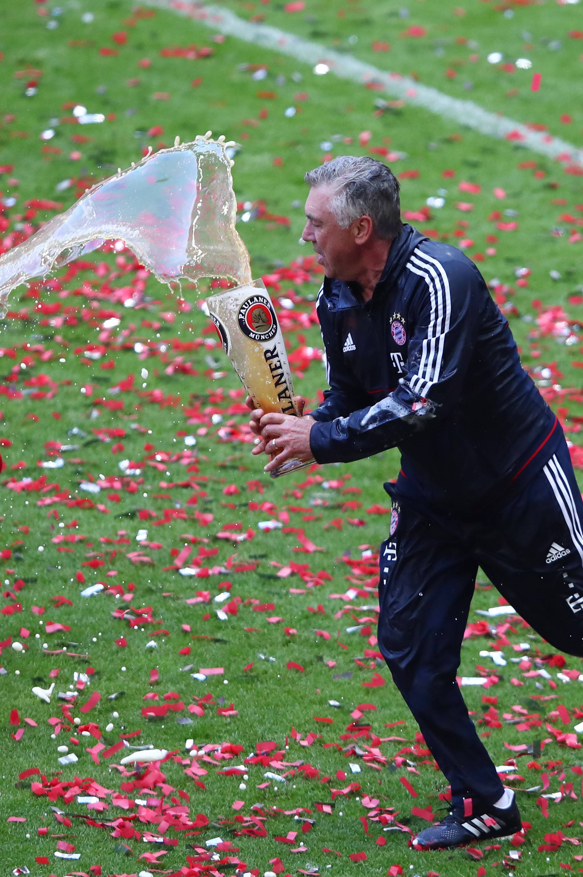 Bayern Munich coach Carlo Ancelotti and Arturo Vidal celebrate after winning the Bundesliga