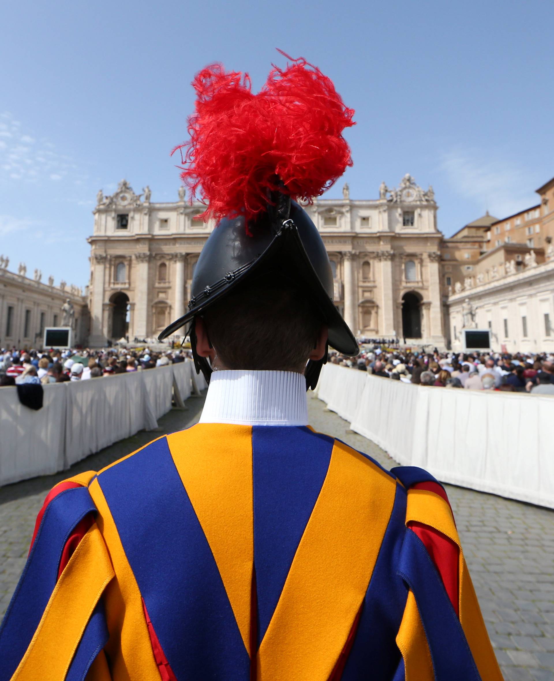 A Swiss guard stands in front of Saint Peter's Basilica during a Holy Mass to mark the feast of Divine Mercy at the Vatican