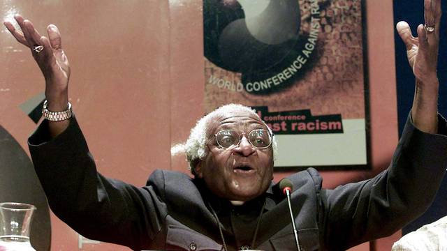 FILE PHOTO: Nobel Peace laureate Archbishop Desmond Tutu gestures as he addresses journalists at the World Confe..