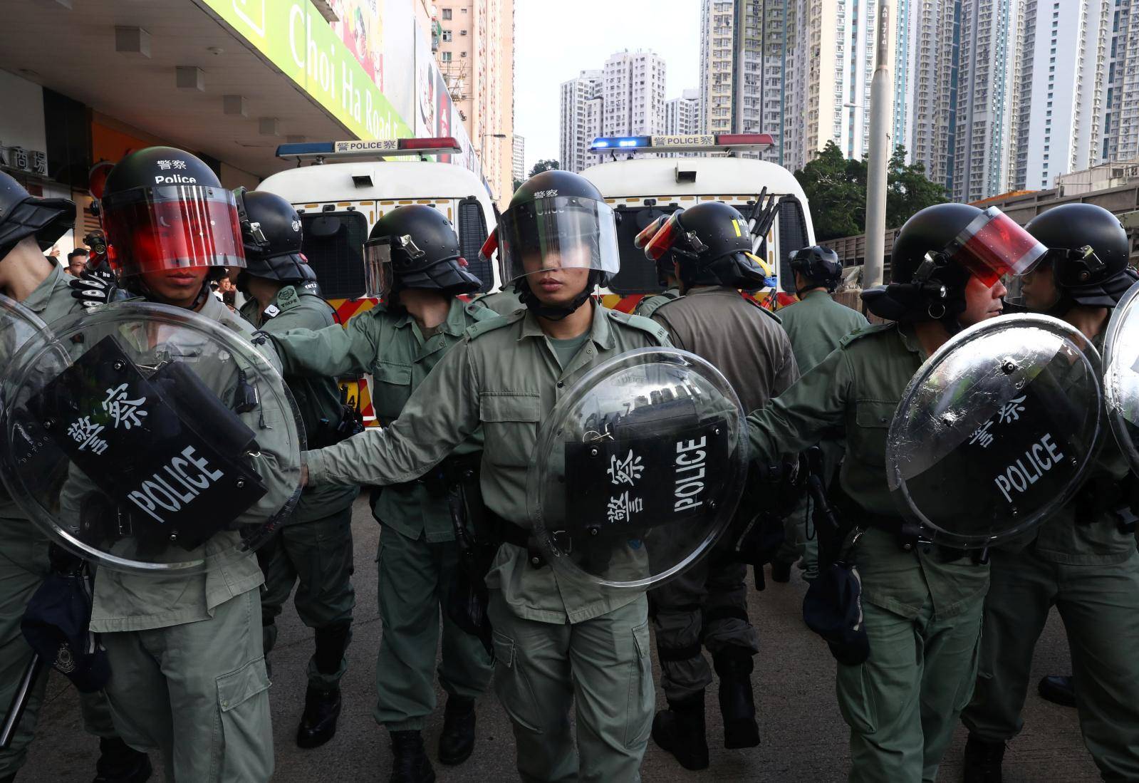 Riot police stand guard near Amoy Plaza shopping mall in Kowloon Bay, Hong Kong