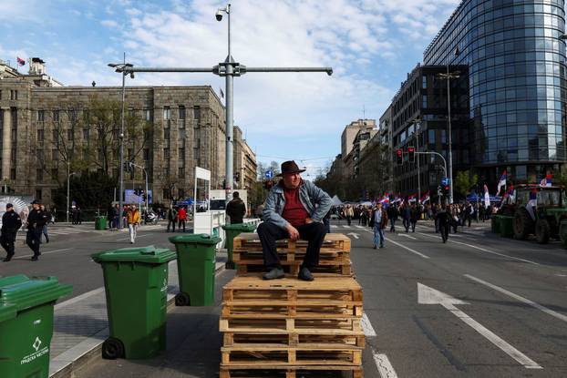 People attend a rally in support of policies of the President Aleksandar Vucic