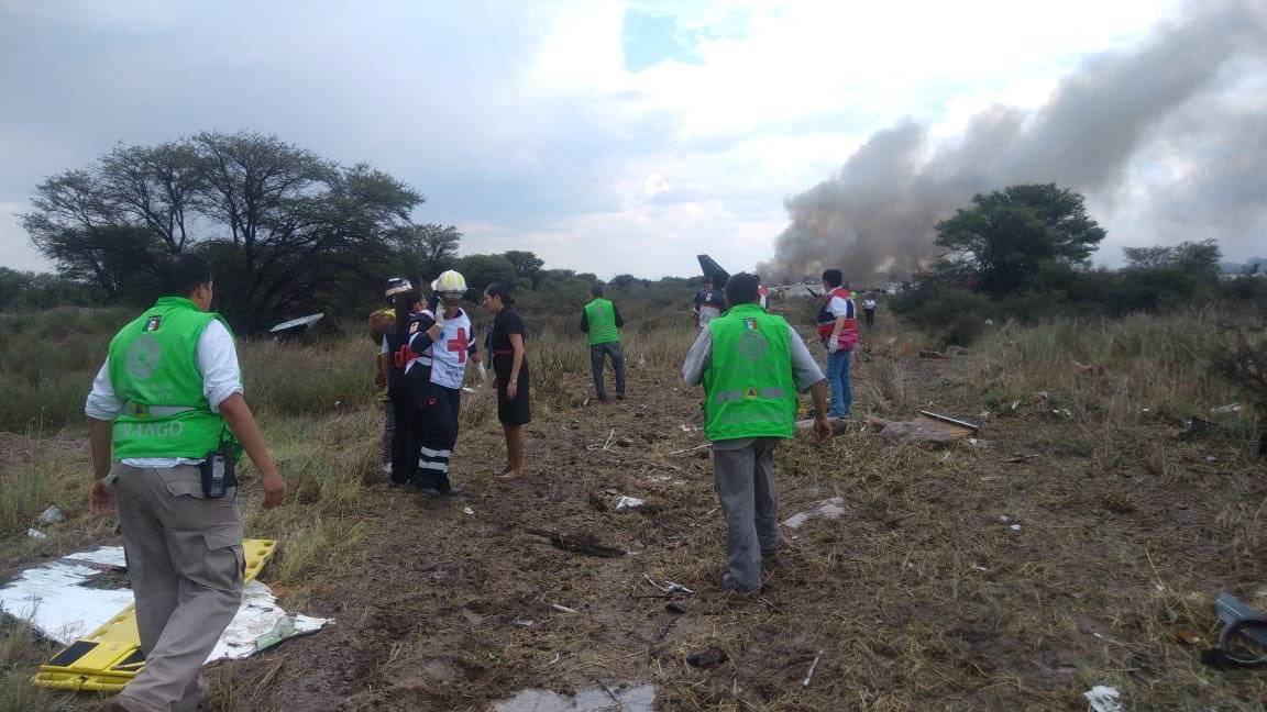 Emergency rescue personnel work at the site where an Aeromexico-operated Embraer passenger jet crashed in Mexico's northern state of Durango