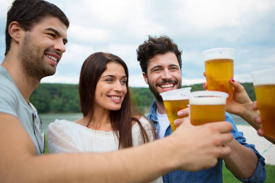 Group of friends holding beers and making a toast