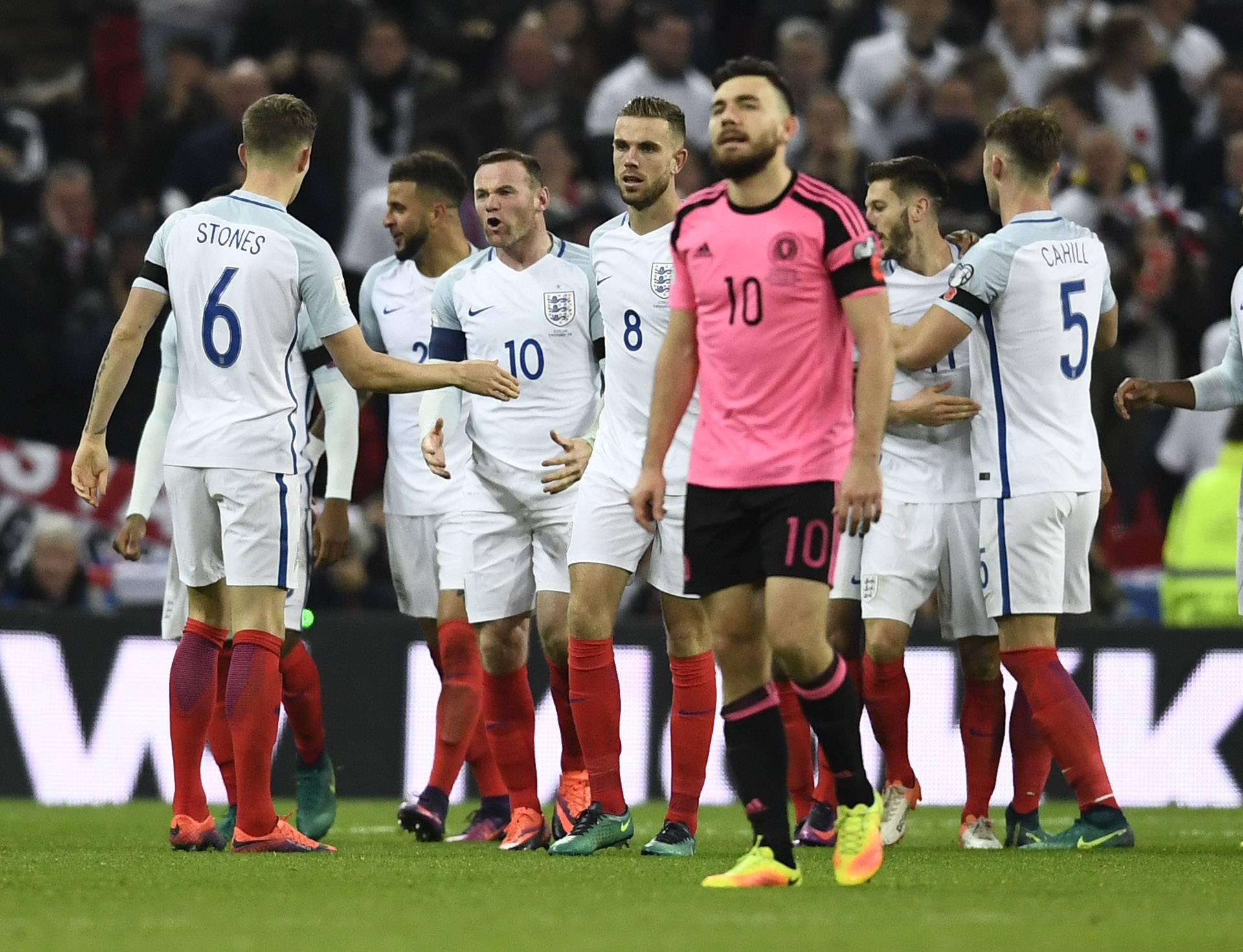 England's Adam Lallana celebrates scoring their second goal as Wayne Rooney shouts at John Stones