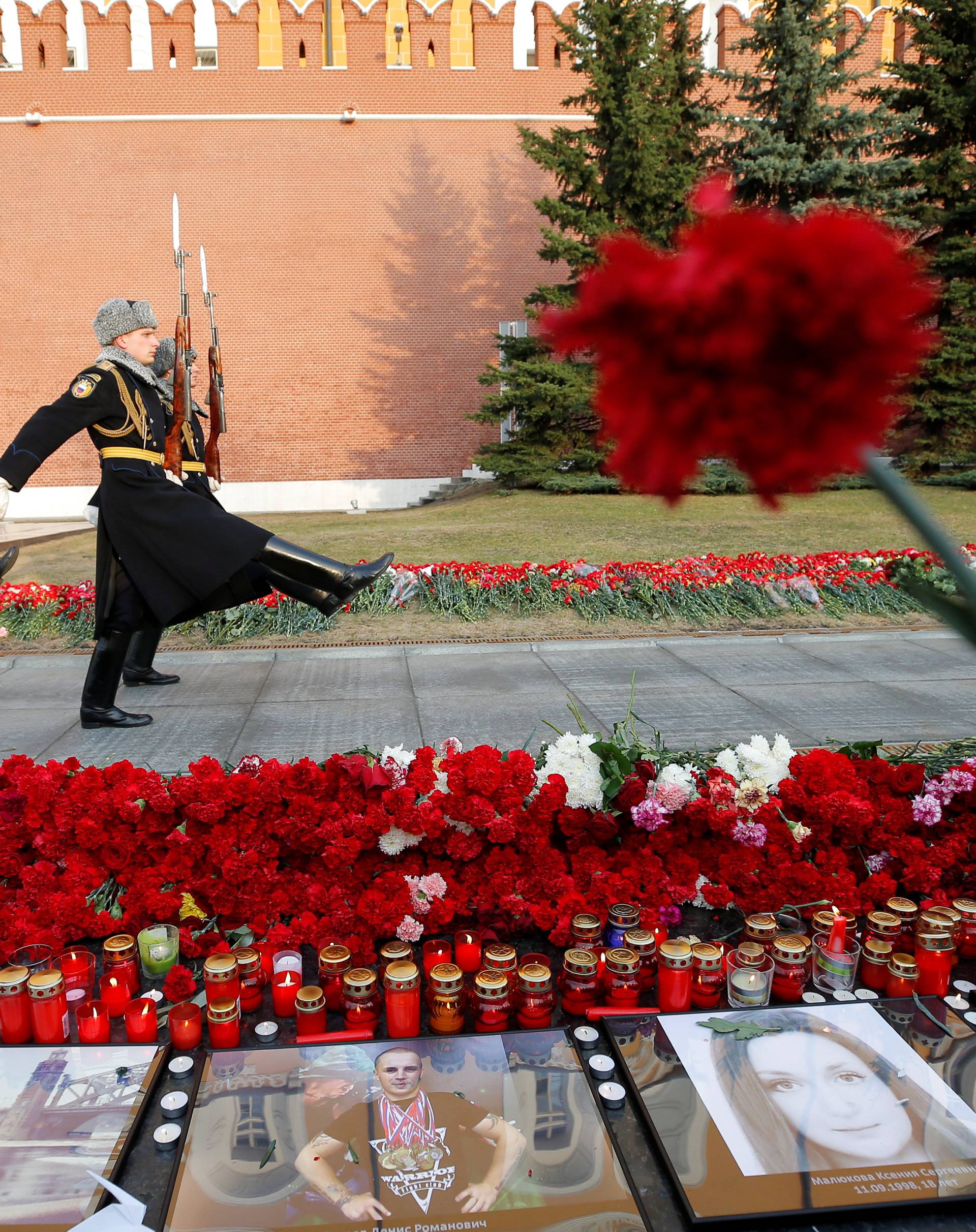 Members of the honour guard march by the Kremlin wall during a memorial commemorating the victims of the St. Petersburg metro blast in Moscow