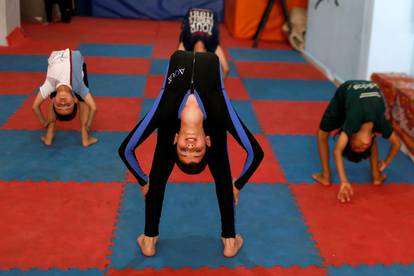 Palestinians perform during a yoga and flexibility class on International Yoga Day amid COVID-19 crisis in Gaza City