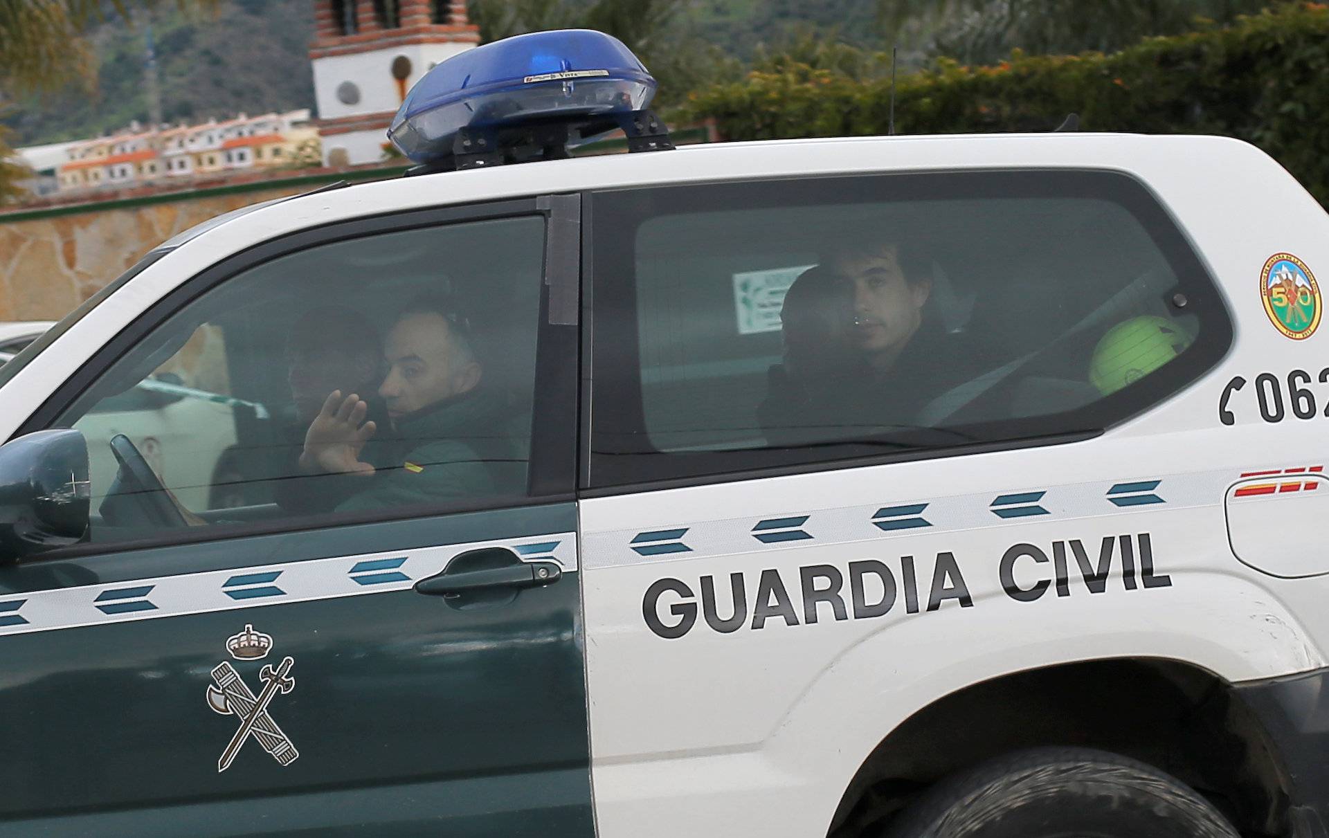 Miner rescue team ride in a police car led by Spanish Civil Guard towards the area where Julen fell into a deep well in Totalan