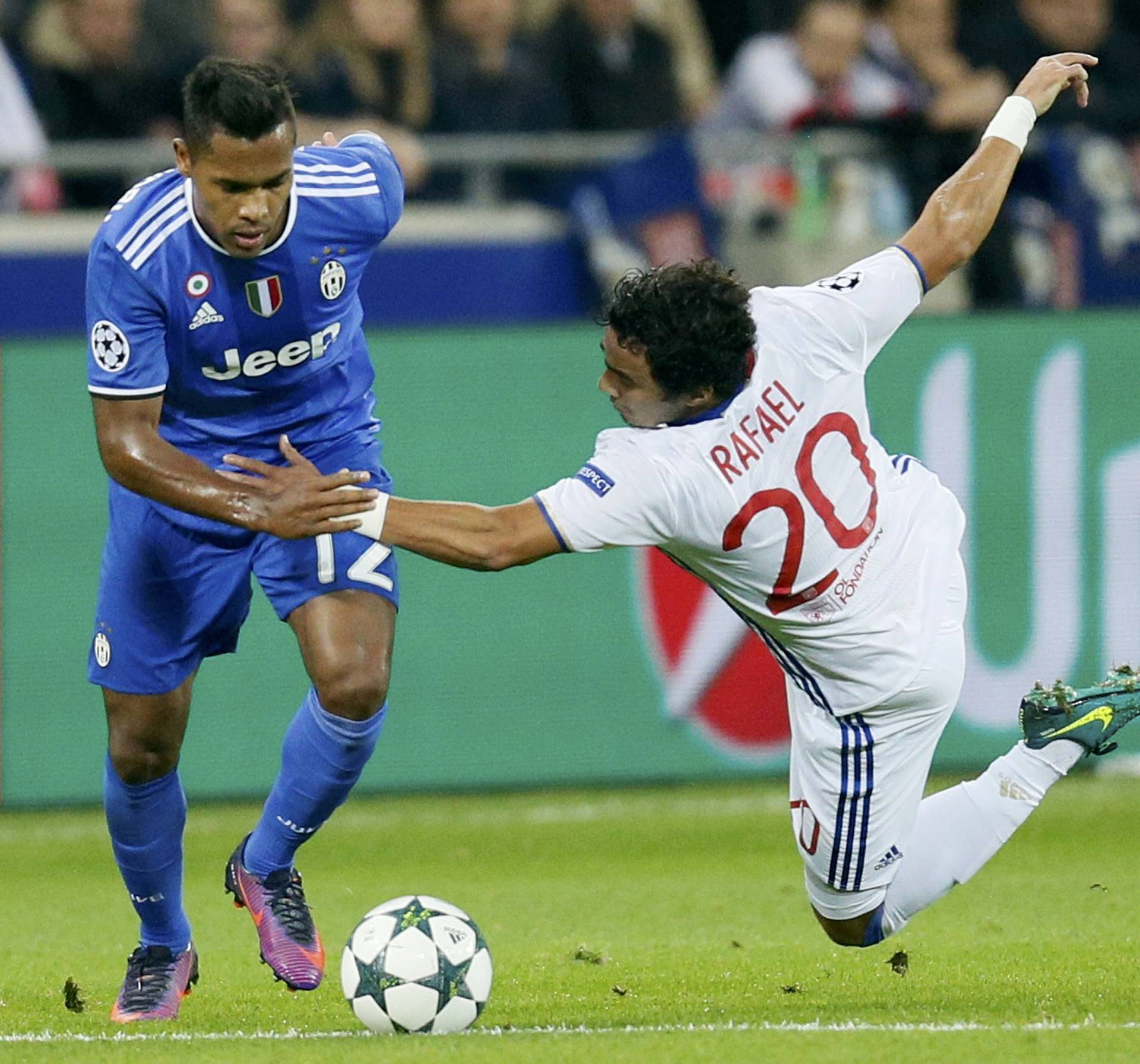 Juventus Alex Sandro in action with Olympique Lyon's Rafael Da Silva