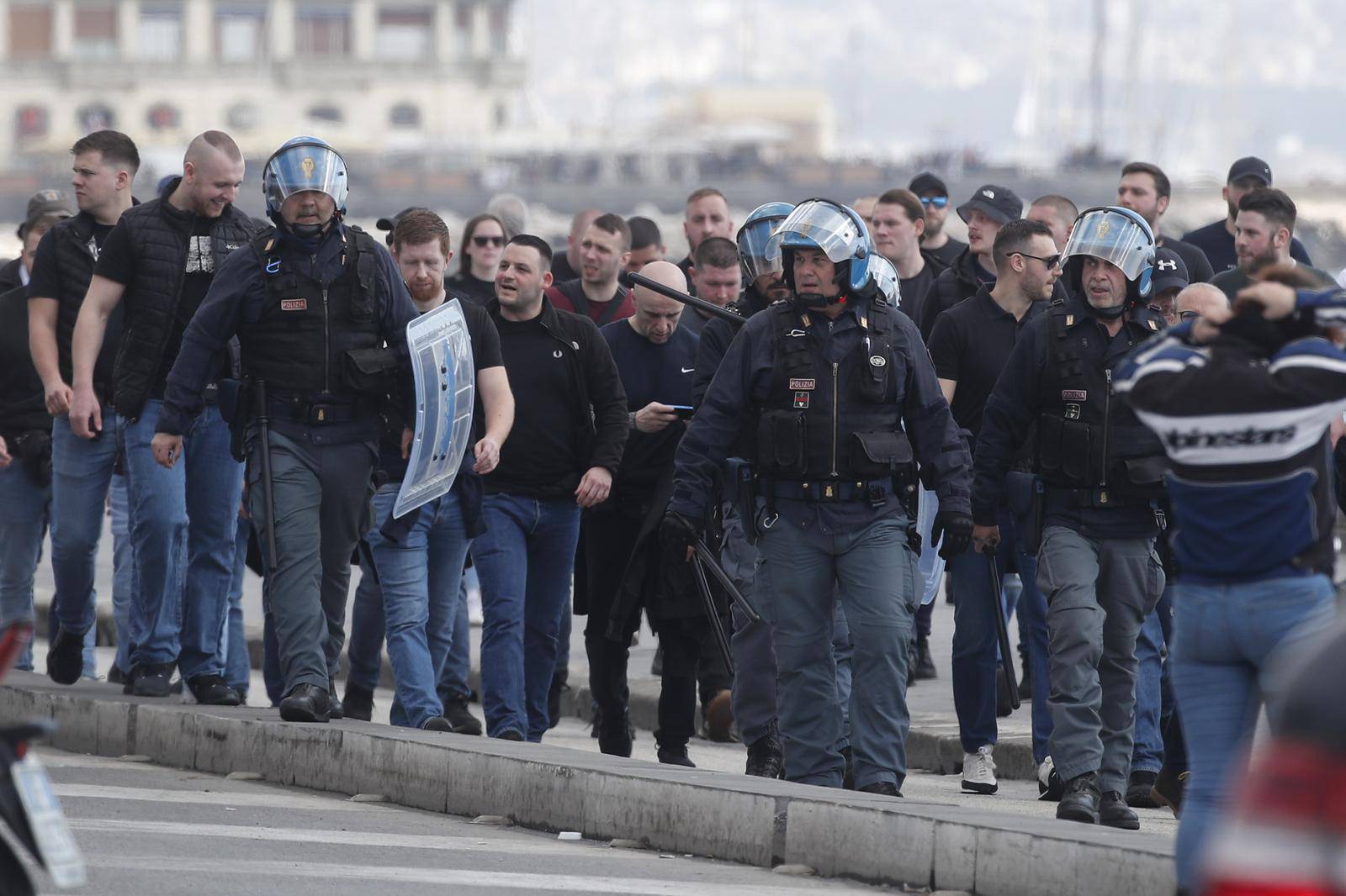 Italian police follow Eintracht Frankfurt fans walking through the streets of the city of Naples before the UEFA Champions League round of 16 return match between SSC Napoli and Eintracht Frankfurt.