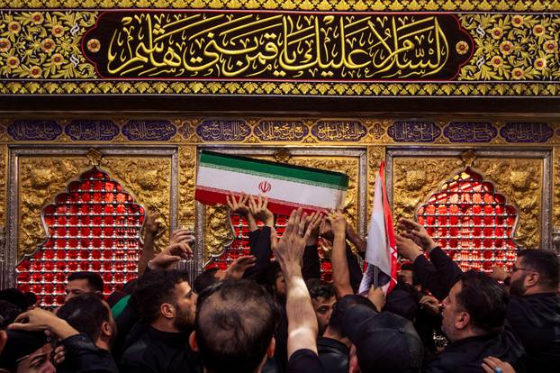 Mourners carry the coffins of family members of Iran’s late Supreme Leader Ayatollah Ali Khamenei, inside the shrine of Imam Abbas during funeral ceremonies in Karbala