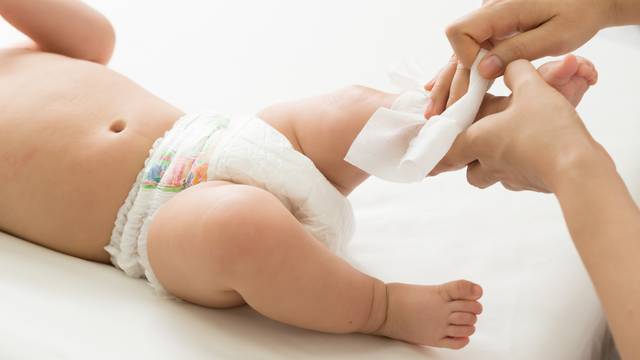 Mother,Cleaning,Up,And,Wipes,Body,And,Leg,Baby,By