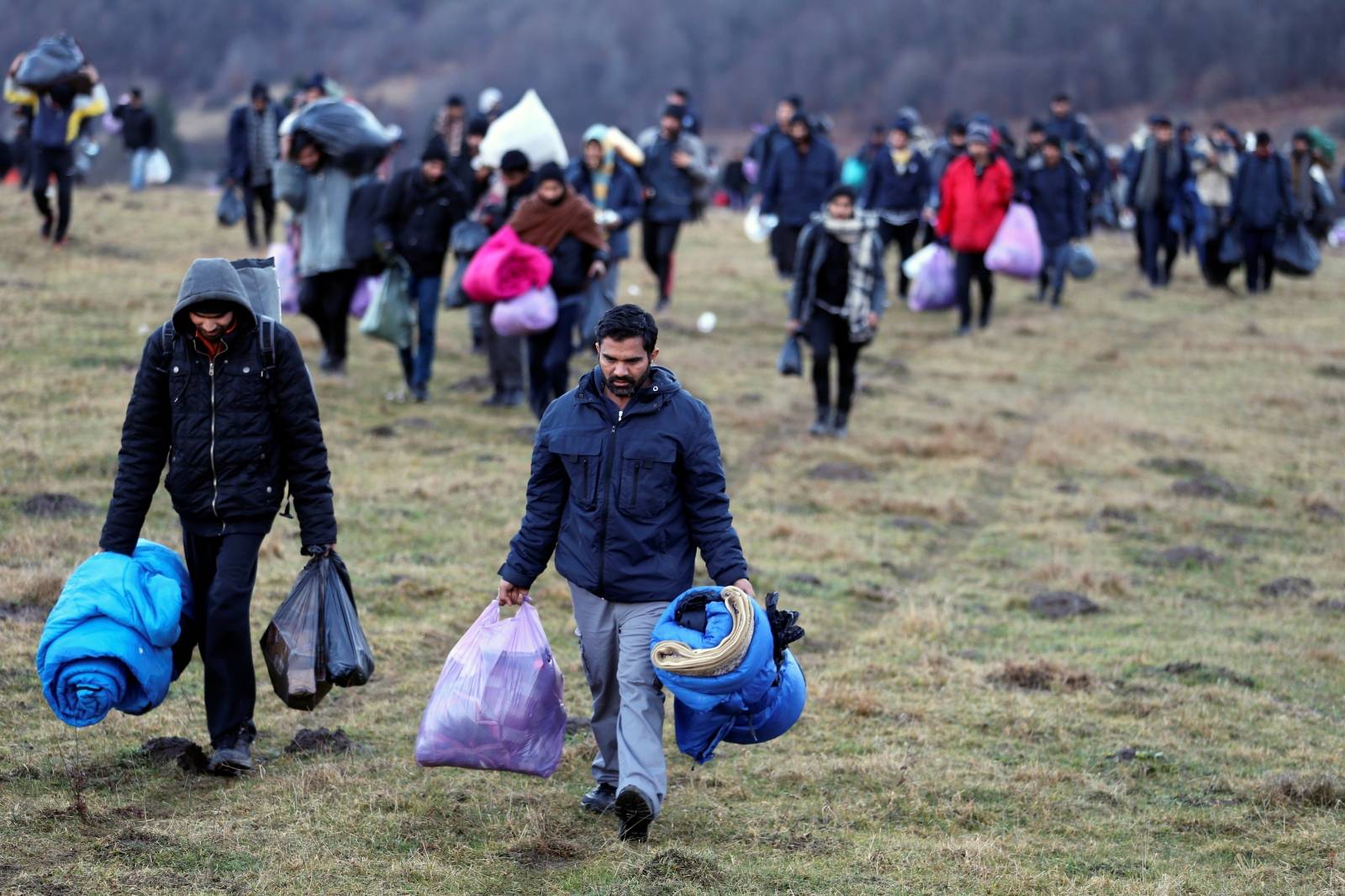 Migrants walk towards the forest after camp "Lipa" was closed, in Bihac