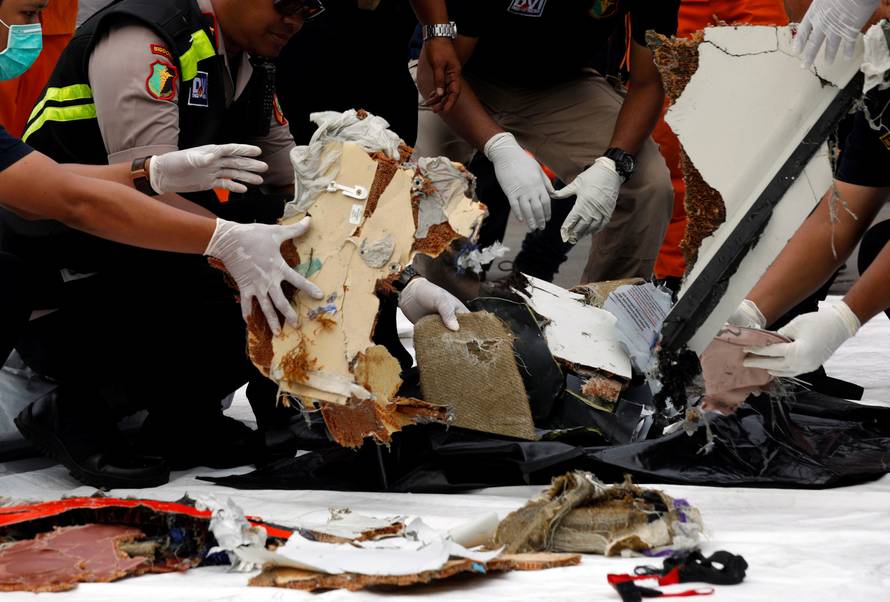 Rescue workers lay out newly recovered debris of Lion Air flight JT610 at Tanjung Priok port in Jakarta