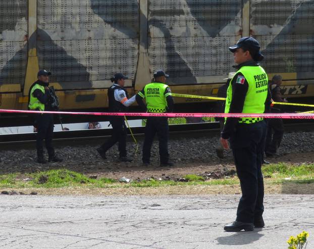 Authorities work at the scene where a passenger bus was struck by a train, in Atlacomulco