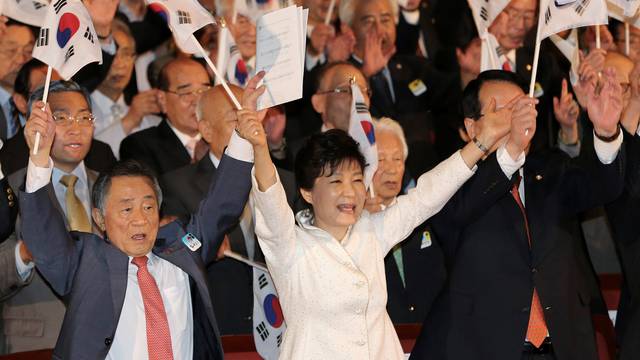 South Korean President Park Geun-hye gives three cheers for the country during a ceremony marking the 69th anniversary of liberation from Japan's 1910-45 colonial rule, on Liberation Day in Seoul