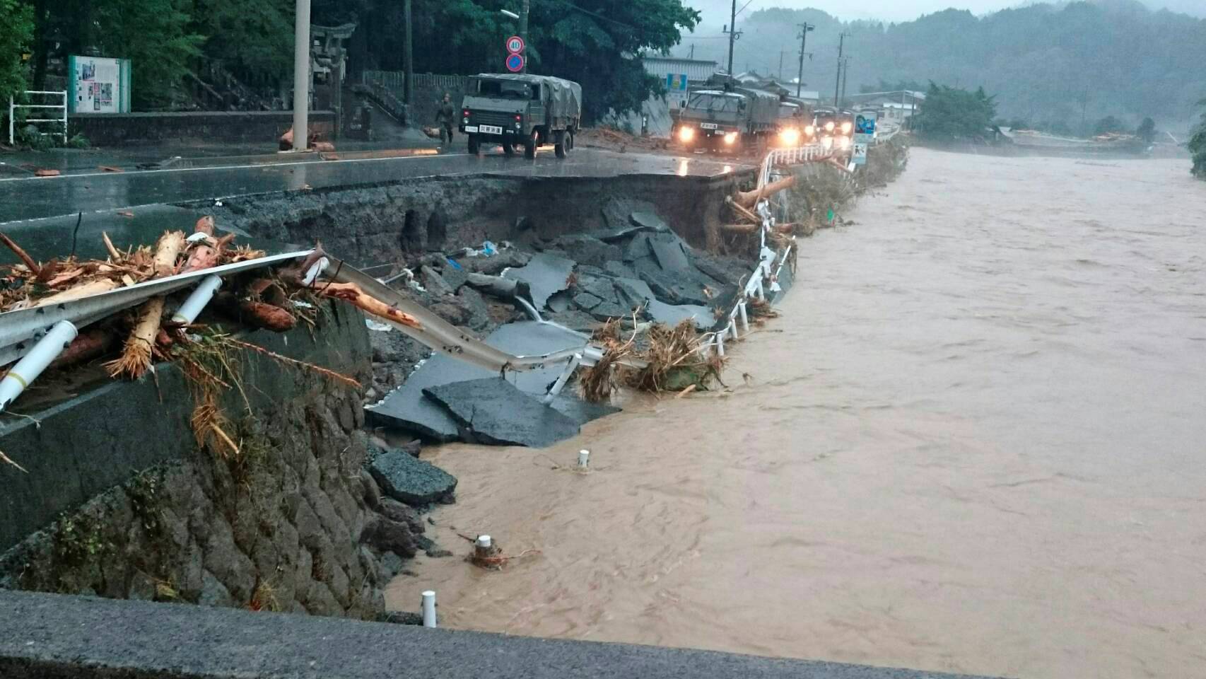 A road is damaged by swollen river after heavy rain hit the area in Toho village