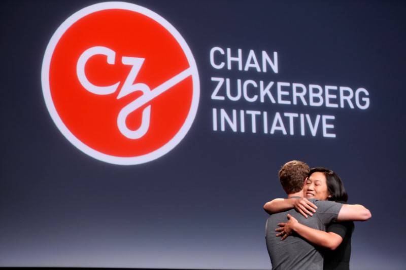 Pricilla Chan embraces her husband Mark Zuckerberg while announcing the Chan Zuckerberg Initiative to "cure, prevent or manage all disease" by the end of the century during a news conference at UCSF Mission Bay in San Francisco
