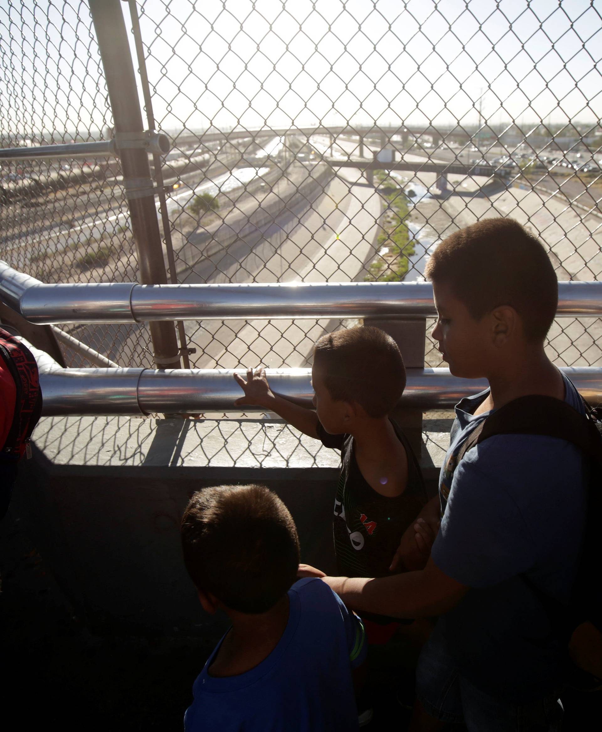 Migrant families from Mexico fleeing from violence wait to enter the United States to apply for asylum at Paso del Norte international border crossing bridge in Ciudad Juarez