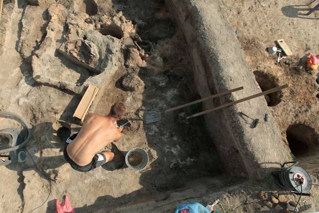 Bulgarian archaeologists dig during excavation works in an ancient settlement near the village of Yunatsite