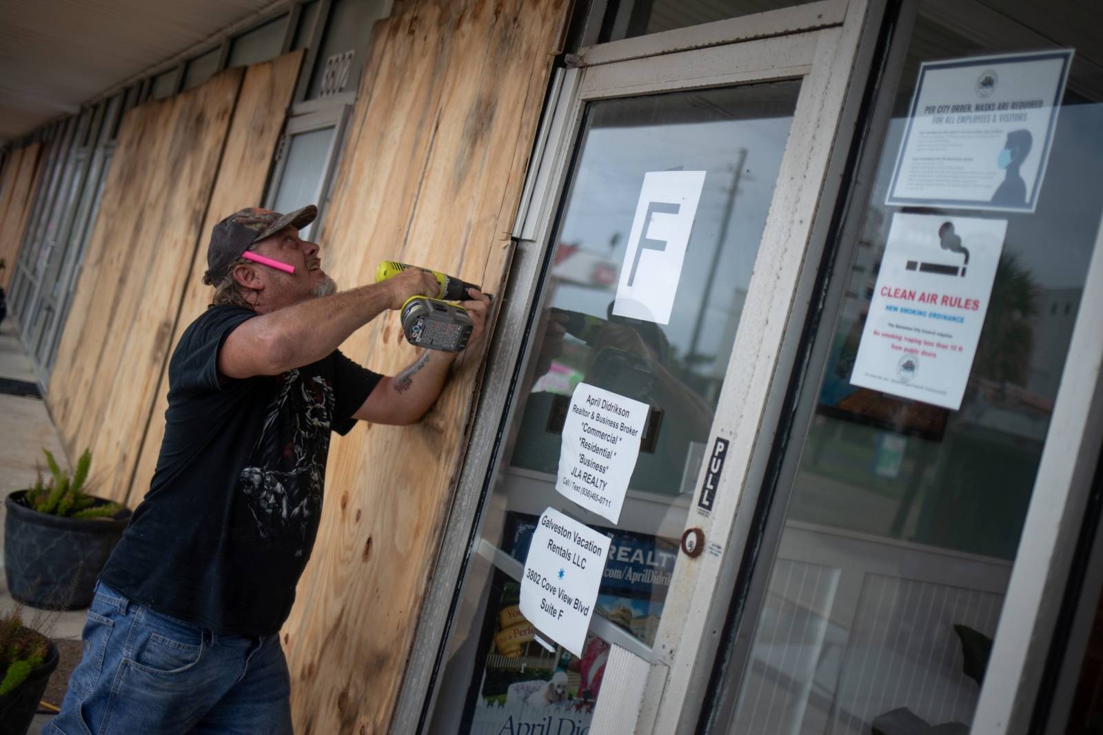 Local resident Robert Sawyer boards up businesses ahead of Hurricane Laura in Galveston, Texas