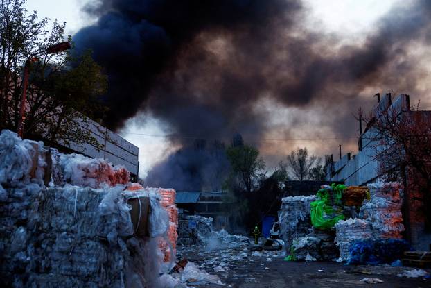 Rescuers work at the site of a Russian missile strike, amid Russia's attack on Ukraine, in Kyiv