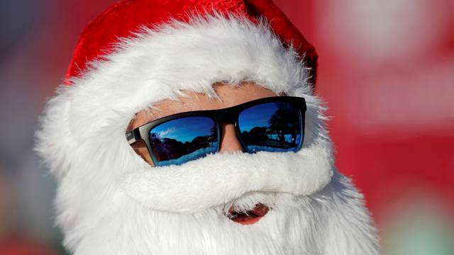 A man dressed as Santa Claus takes part in the annual race known as "Run Santa Run" at Fundidora Park in Monterrey