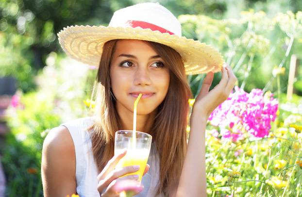 Beautiful girl drinking juice