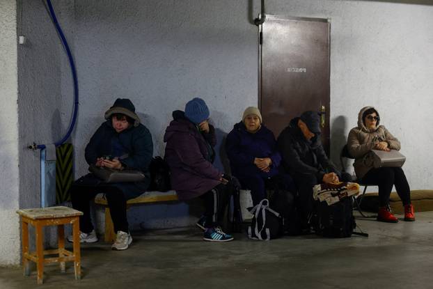 People take shelter inside an underground parking lot during a Russian missile and drone attack in Kyiv