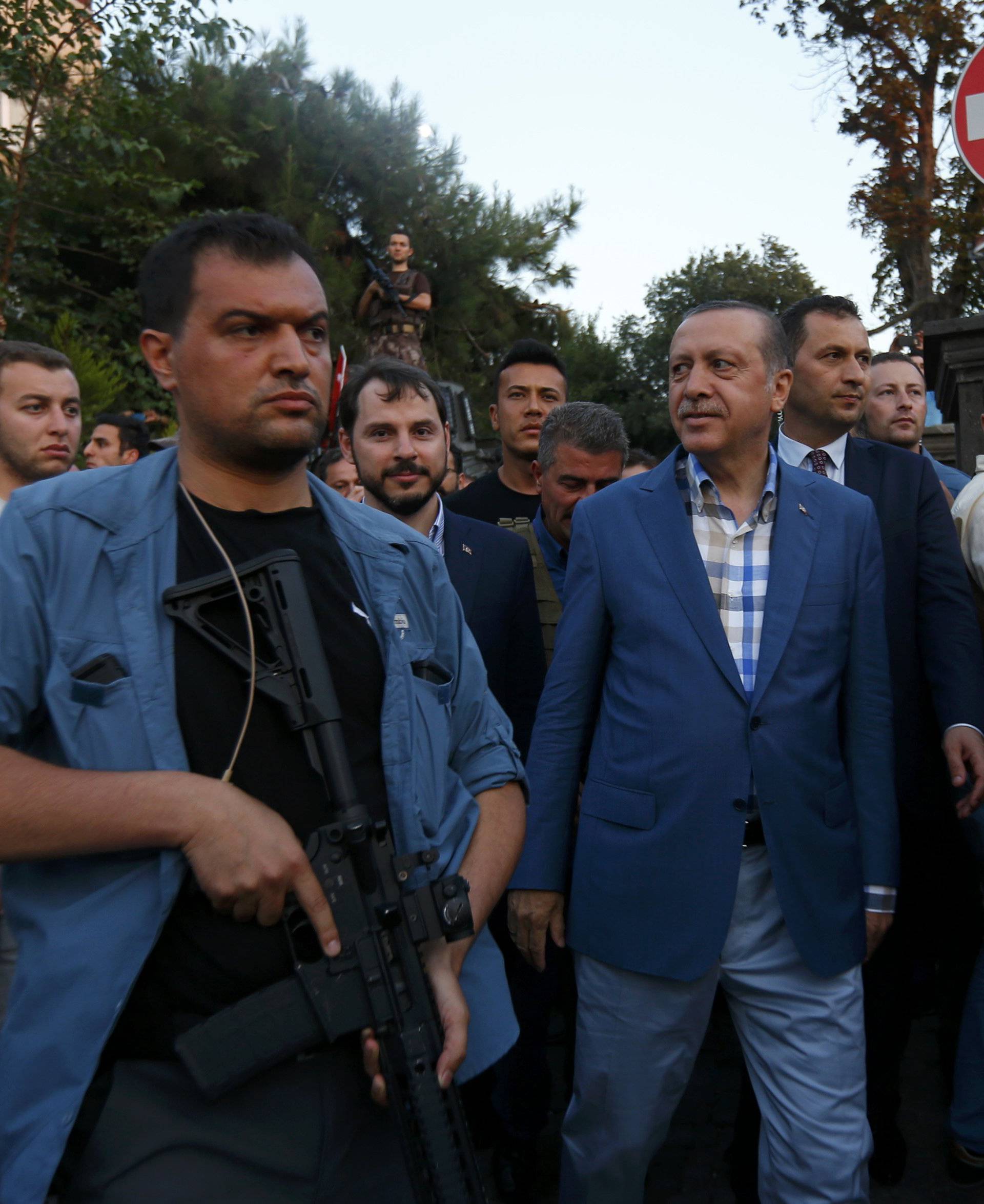 Turkish President Tayyip Erdogan walks through the crowd of supporters protected by bodyguards in Istanbul