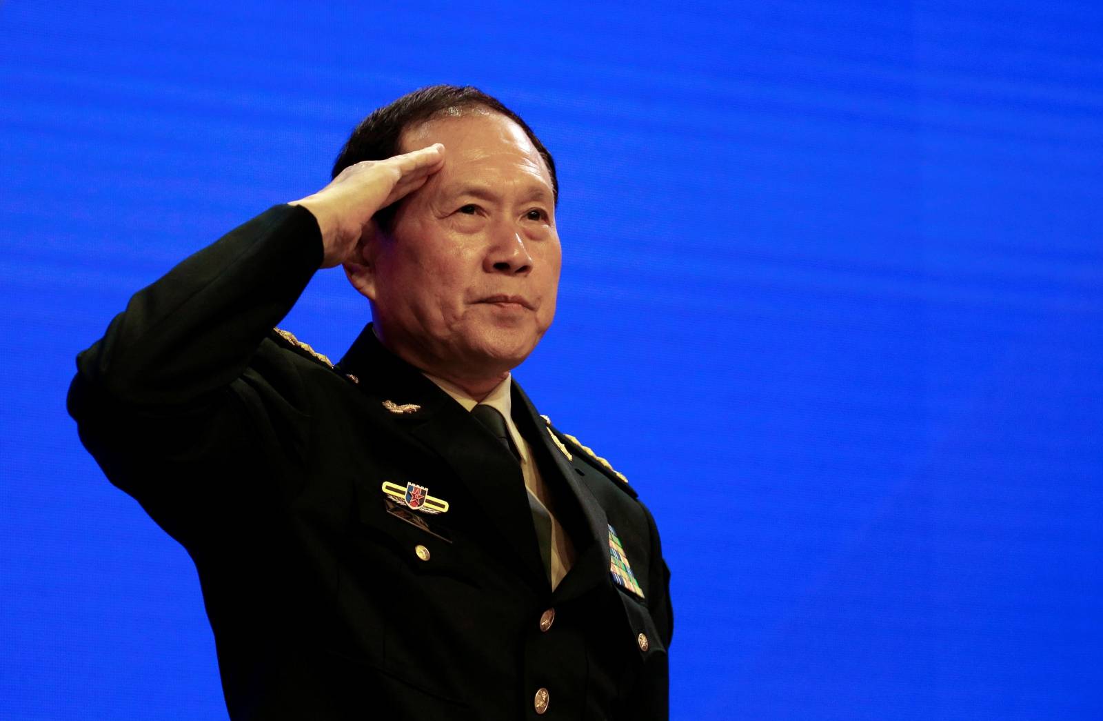 Chinese Defense Minister Wei Fenghe salutes at the IISS Shangri-la Dialogue in Singapore