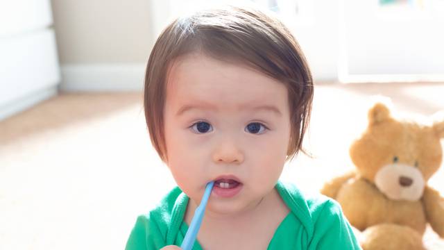 Toddler boy brushing his teeth