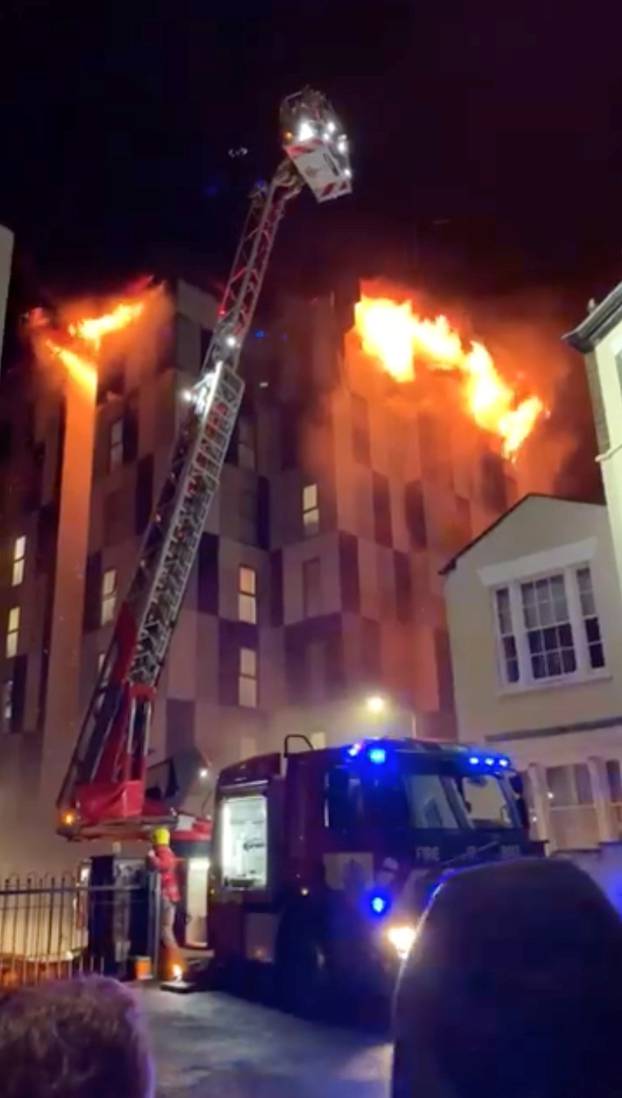 A student accommodation building on fire is pictured in Bolton