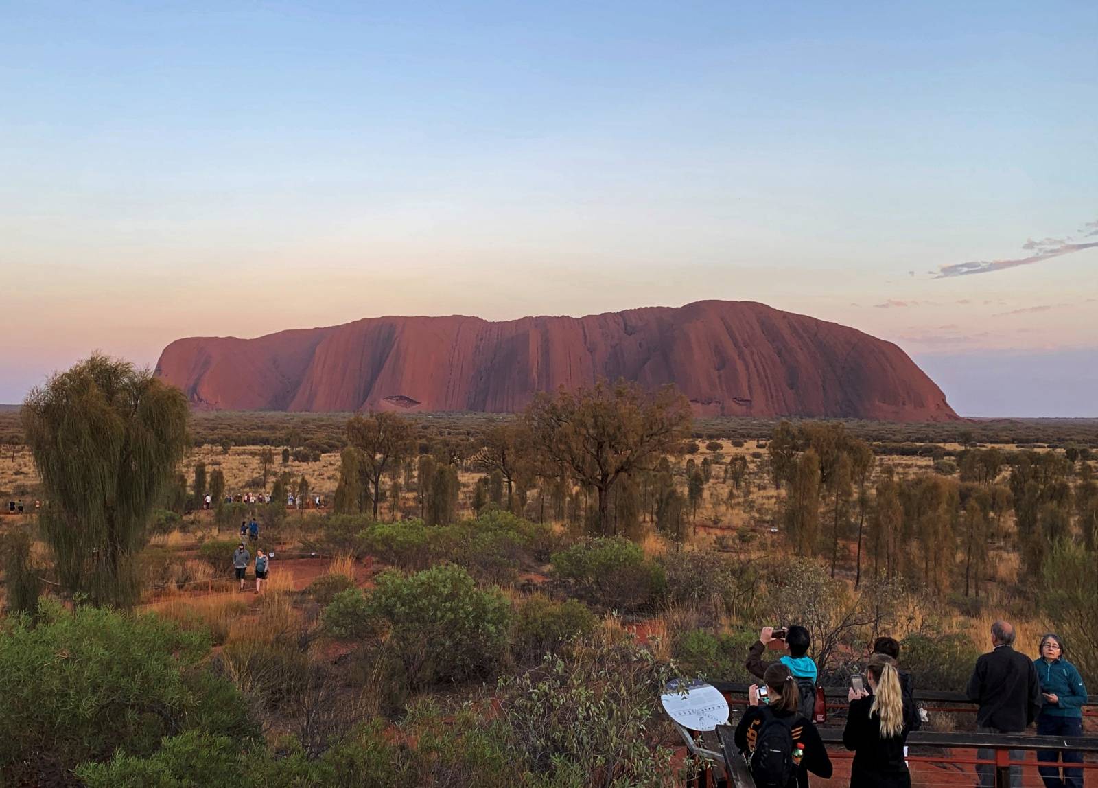 People view Uluru, the day before a permanent ban on climbing the monolith takes effect following a decades-long fight by indigenous people to close the trek, near Yulara