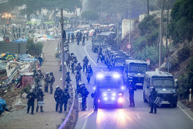 Spanish police clear an encampment of migrants at El Trampolin beach in the Spanish enclave of Ceuta