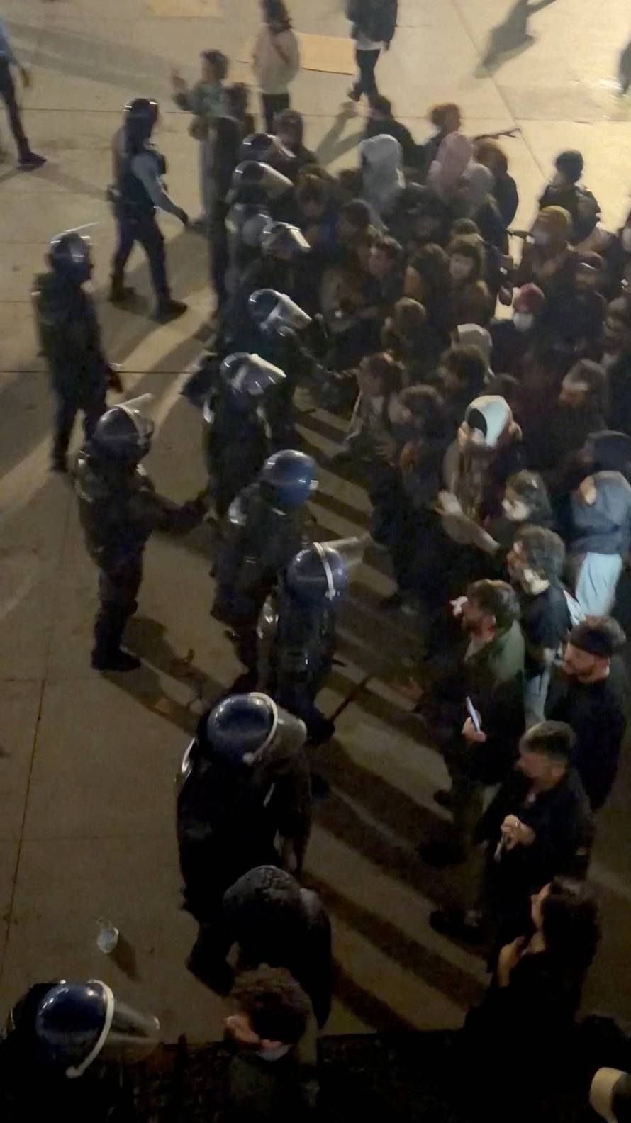 Demonstrators and police face off during a housing-rights protest in Porto