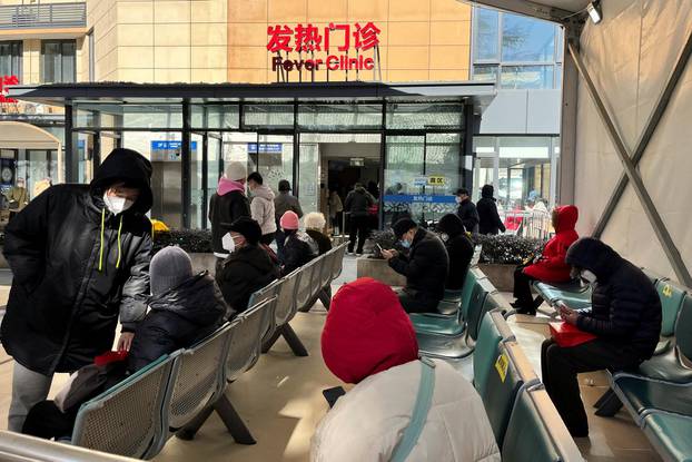 People wait outside a fever clinic at a hospital as coronavirus disease (COVID-19) outbreak continues, in Shanghai