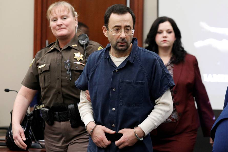 Larry Nassar, a former team USA Gymnastics doctor, who pleaded guilty in November 2017 to sexual assault charges, is escorted into the courtroom during his sentencing hearing in Lansing