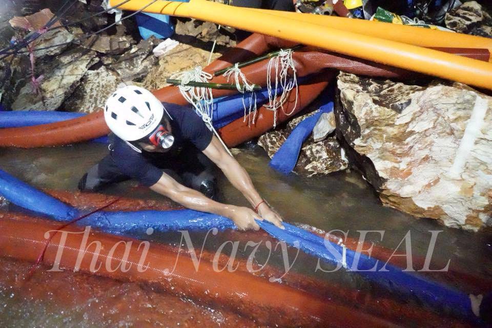 Rescue personnel work at the Tham Luang cave complex, as members of an under-16 soccer team and their coach have been found alive according to local media, in the northern province of Chiang Rai