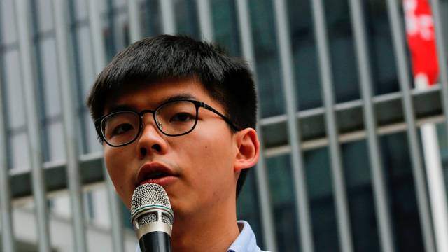 Pro-democracy activist Joshua Wong speaks to journalists after being disqualified from running in the local district's council elections in November, in Hong Kong